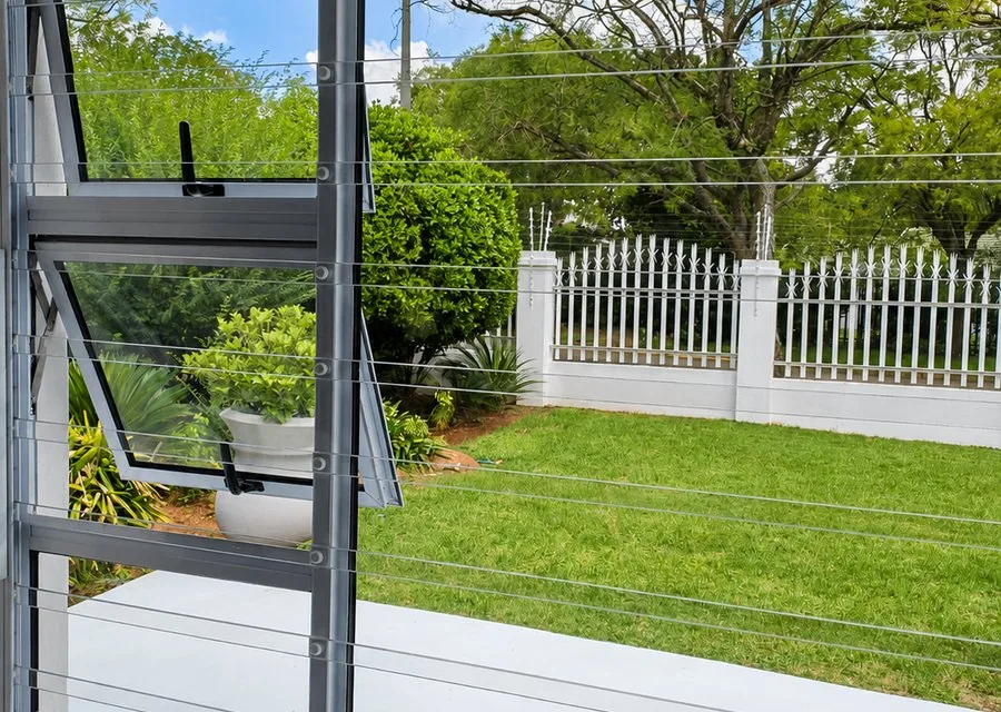 Clear burglar bars installed on modern home window